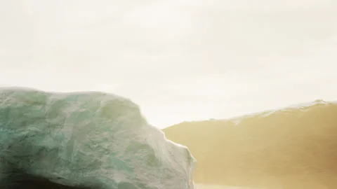 Sunset over a large iceberg in a cold ocean landscape Stock Footage 344825056
