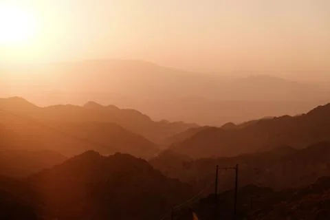 Sunset over layer of mountain ranges. Stock Photos
