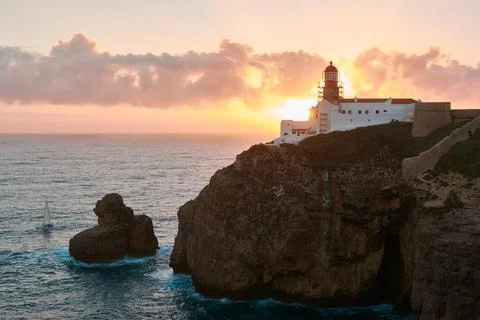 Sunset over the Lighthouse of Cabo de Sao Vicente near Sagres, Portugal Stock Photos