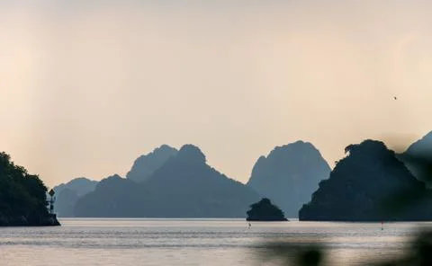 Sunset over limestone islands in Ha Long Bay, UNESCO site in Northern Vietnam Stock Photos