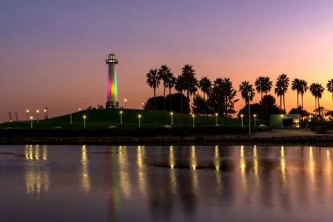 Sunset Over Long Beach Lighthouse, with Lights Reflecting on Water Stock Photos