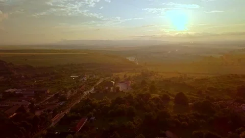 Sunset over low mountains and village Video stock 111970485