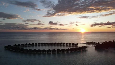 Sunset over Maldives Over Water Bungalows Aerial View Stock Footage 279916596