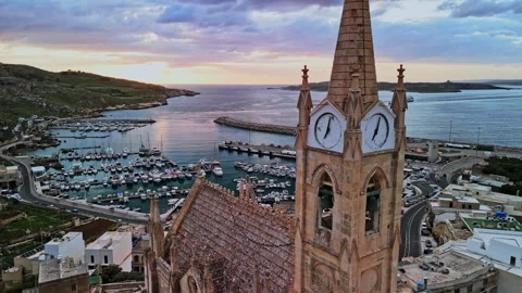 Sunset over Malta with coastline, harbor, and clock tower Stock Footage 306642932