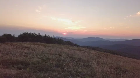 Sunset over meadow in mountains landscape Aerial view Stock Footage 93863005
