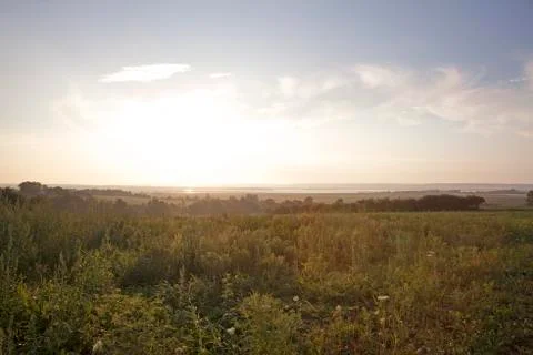 Sunset over a meadow Stock Photos