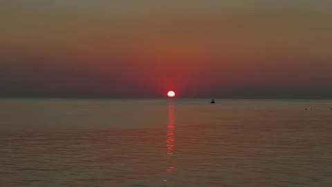 Sunset over Mobile Bay and fishing boat going by near Fairhope Alabama Stock Footage 332629591