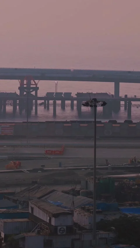 Sunset over a modern bridge with construction activity below. Stock Footage 341170963