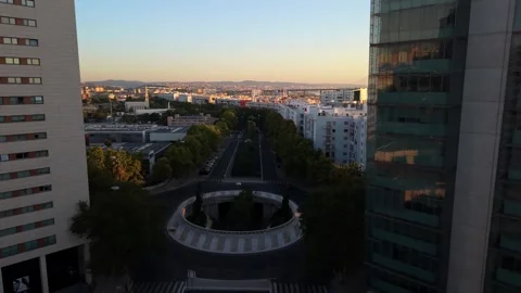 Sunset over modern city with roundabout and surrounding towers Parque das Nacoes Video stock 346070747