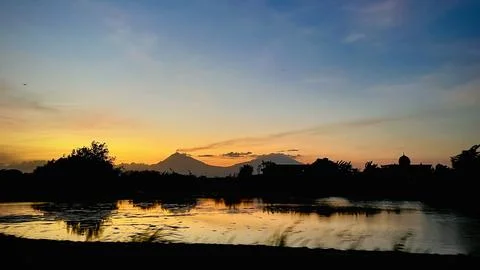 A sunset over Mount Merapi, an active volcano in Central Java, Indonesia. Stock Photos