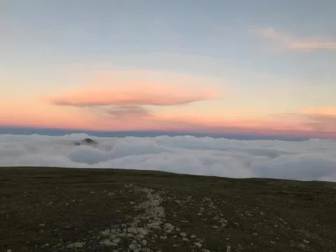 Sunset over mountain hill with clouds and colorful sky Stock Photos