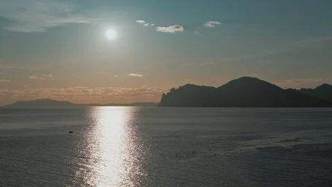 Sunset over the mountain Karadag and a fisherman in a small boat Vidéo 129236898
