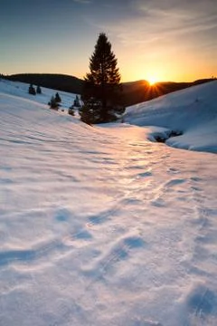 Sunset over mountain meadows in snow Stock Photos