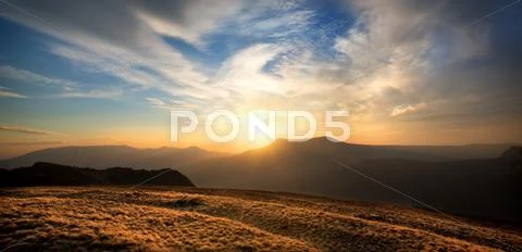 Sunset over the mountain Stock Photos