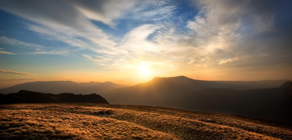 Sunset over the mountain Stock Photos