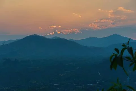 Sunset over mountain range with colorful sky and clouds Stock Photos
