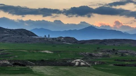 Sunset over a mountain range landscape Stock Photos