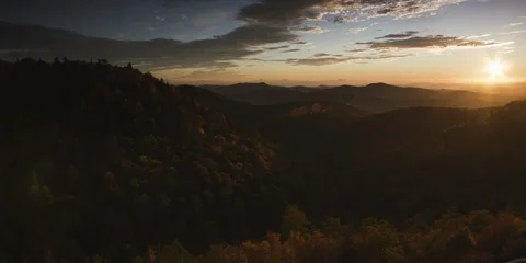 Sunset over the mountain ranges and the forest Stock Footage 103397630