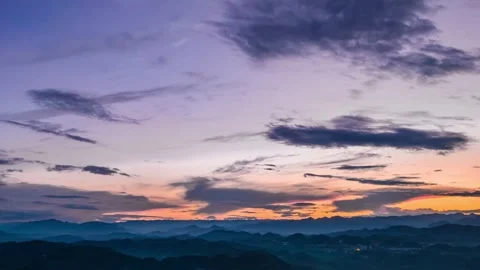 Sunset Over Mountain Ranges With Vibrant Clouds And Shifting Atmospheric Light Video stock 347038858