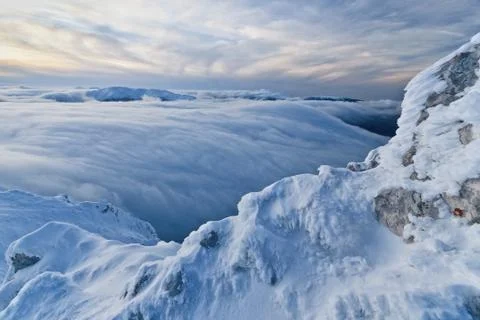 Sunset over the mountains and clouds in winter Stock Photos