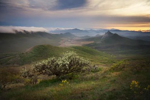 Sunset over the mountains with clouds Stock Photos