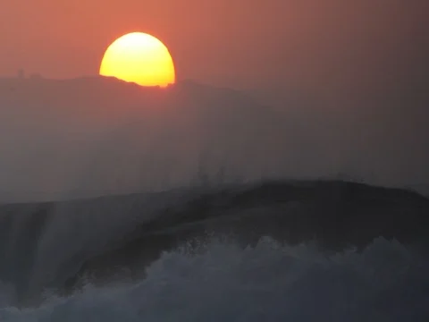 Sunset over mountains with foreground waves Stock Footage 72449795