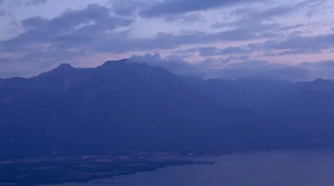 Sunset over the mountains next to a lake Stock Footage 41497386