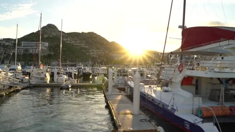 Sunset over mountains at pier with party boats and yachts Stock Footage 248477321