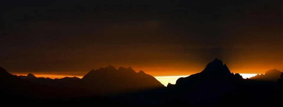 Sunset over the mountains reflections in the upper Brembana valley banner Stock Photos