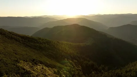 Sunset over mountains in a rural area, capturing changing light and shadows. Stock Footage 327445798