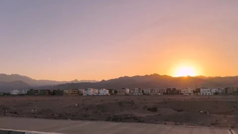 Sunset over mountains seen from moving car window Vidéo 341837759