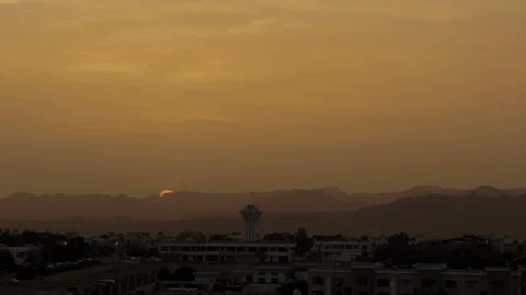 Sunset over the mountains in Sharm El Sheikh, Egypt. A huge sun sets over the Stock Footage 91199032