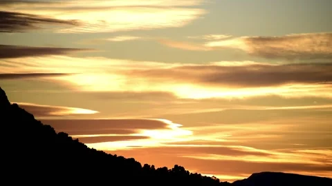 Sunset over mountains. Time-lapse of the sun setting and clouds passing 動画素材 145833581