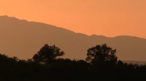 SUNSET OVER MOUNTAINS ZOOM OUT Stock Footage 10710935
