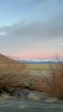 Sunset over moving mountain range landscape Stock Photos