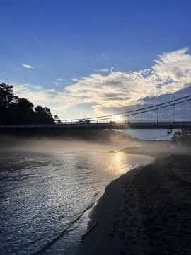 Sunset over Napo River and suspension bridge in Tena Ecuador Stock Photos