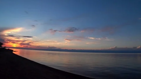 Sunset over the ocean and mountains Stock Footage 80734683