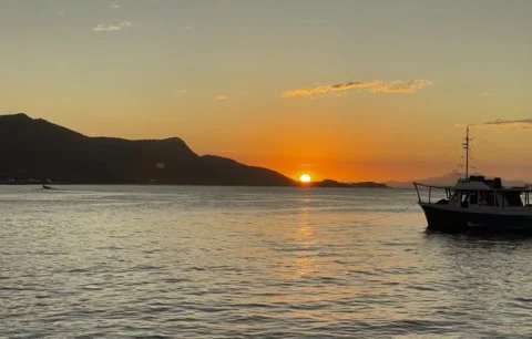 Sunset Over Ocean Bay with Boat, Mountains and Bird Flying Video stock 343276056