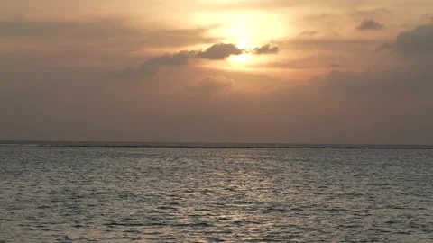 Sunset over ocean with beautiful clounds. Amazing color of the sky. Calm water Stock Footage 192978973