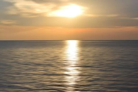 Sunset over the ocean. Blurry ocean landscape background and sunset view. B.. Stock Photos