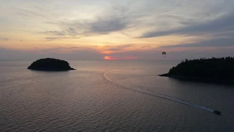 Sunset over ocean with boat and island, gradual color change in sky Stock-Footage 342331612