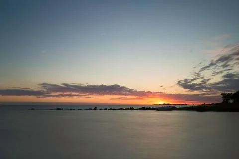 Sunset over Ocean with Breakwater Stock Photos
