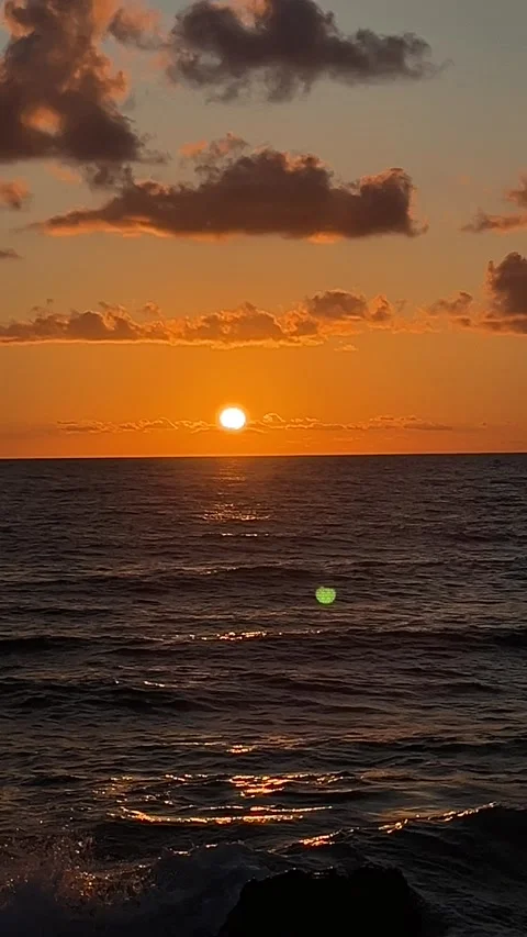 Sunset Over the Ocean on a Calm Evening at the Beach in a Coastal Location Stock Footage 322937451