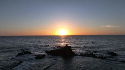 Sunset Over Ocean with Calm Waves Rolling Over Rocks – Gran Canaria Aerial Stock Footage 309945728