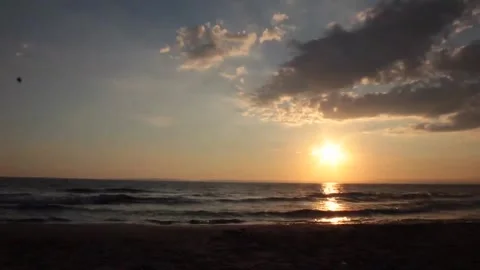 Sunset Over Ocean with Clouds and Gentle Waves Video stock 327269243