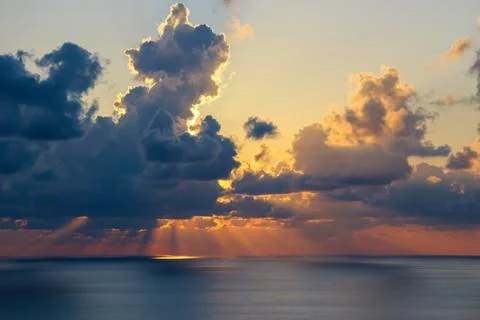 Sunset over the Ocean with Clouds Stock Photos