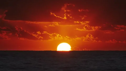 Sunset over ocean with dramatic clouds at dusk Stock Footage 294980310