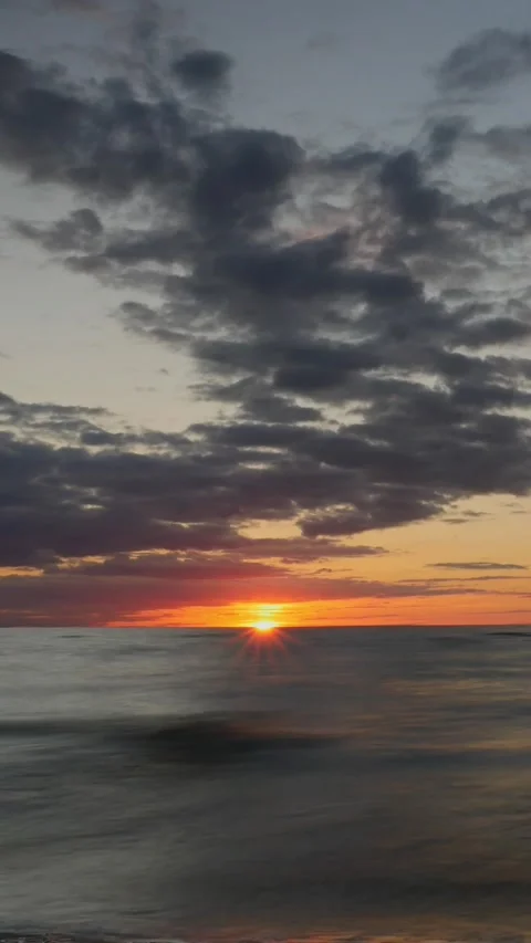 Sunset over ocean with dramatic clouds. Vertical video Stock Footage 304465255
