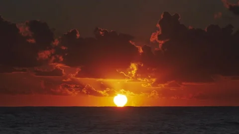 Sunset over ocean with dramatic clouds at dusk Stock Footage 304703282