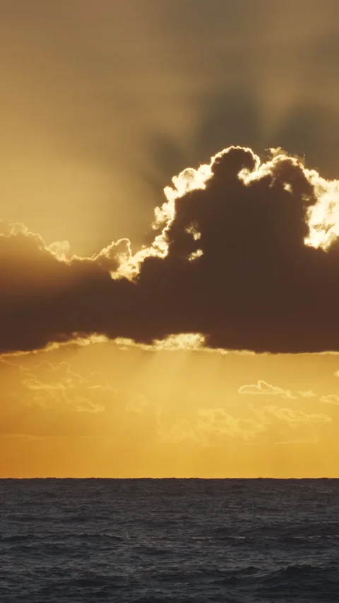 Sunset over ocean with dramatic clouds at dusk Stock Footage 306025230